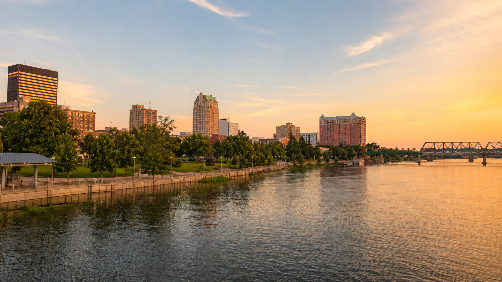 Augusta skyline at golden hour with Savannah River waterfront, downtown buildings, riverwalk and bridge views in Georgia.