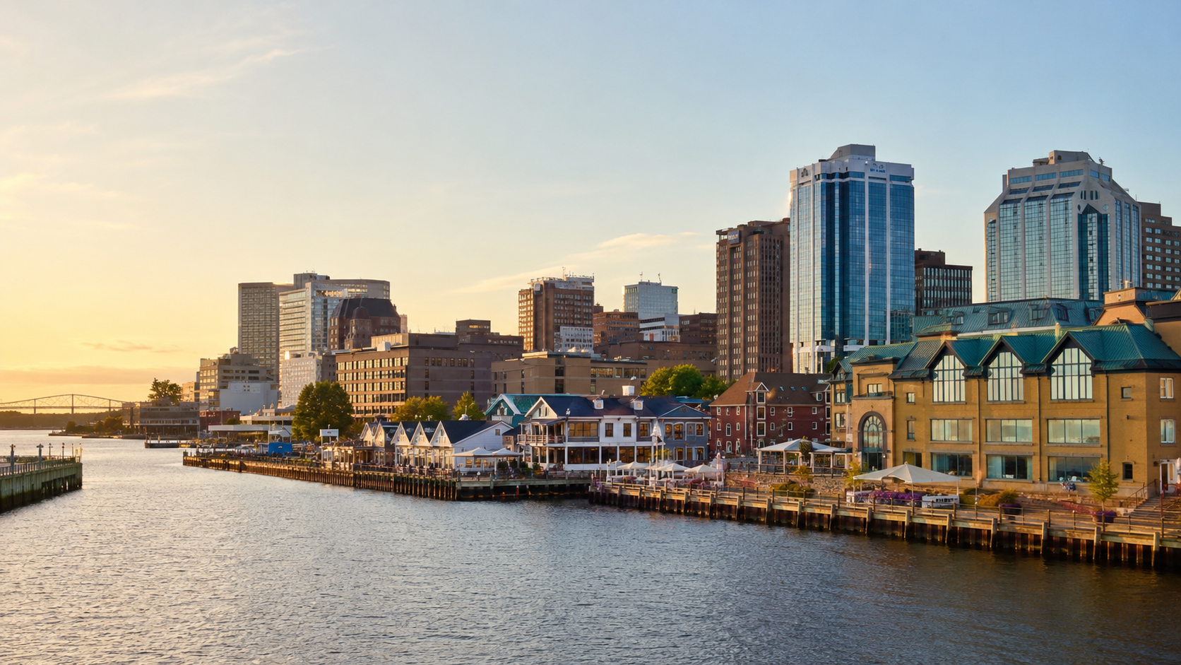 Halifax waterfront skyline at golden hour with harbour views, downtown buildings, boardwalk and waterfront restaurants in Nova Scotia.