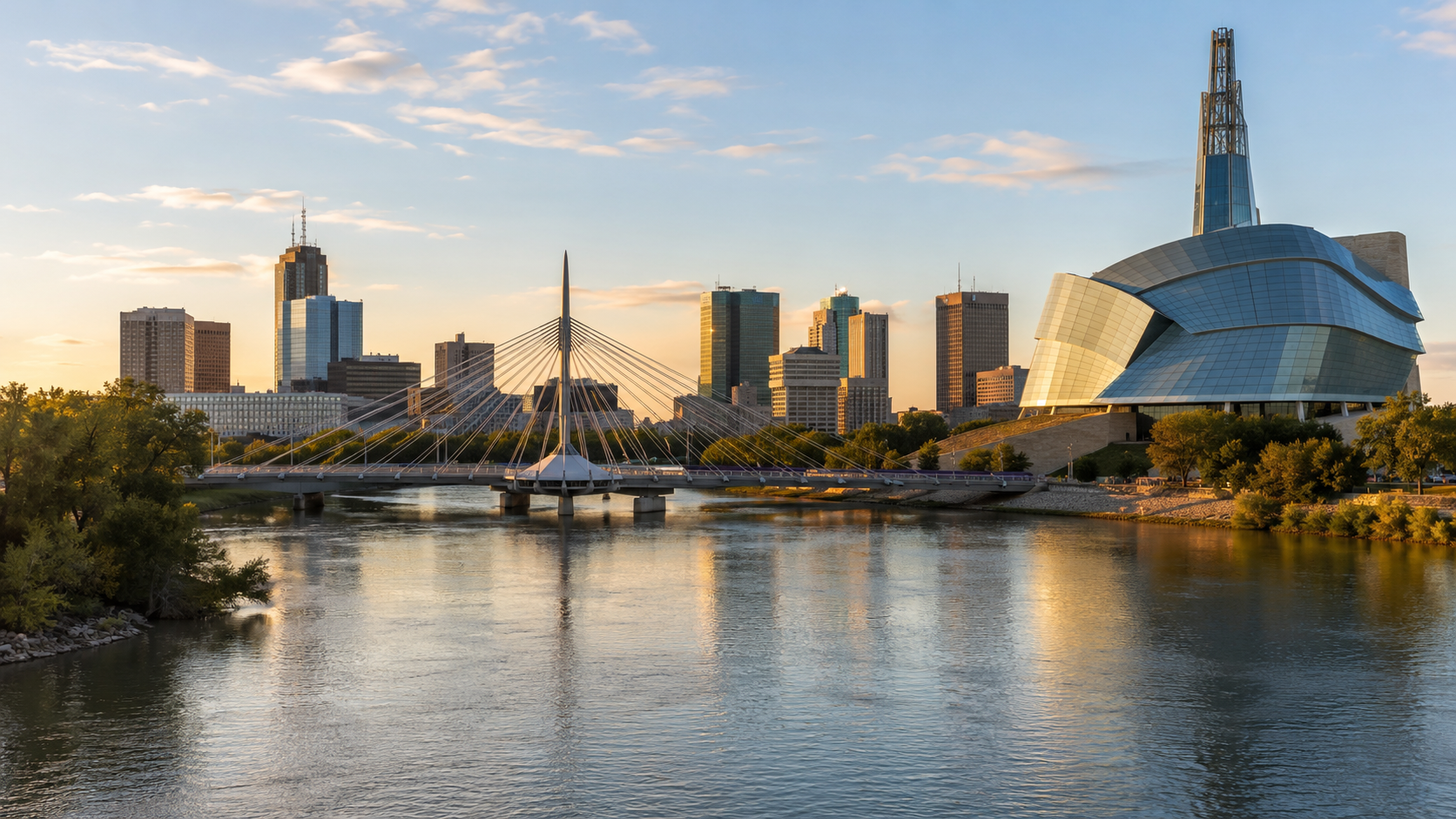 Winnipeg skyline at golden hour with Esplanade Riel, Canadian Museum for Human Rights and Red River reflections in Manitoba, Canada.