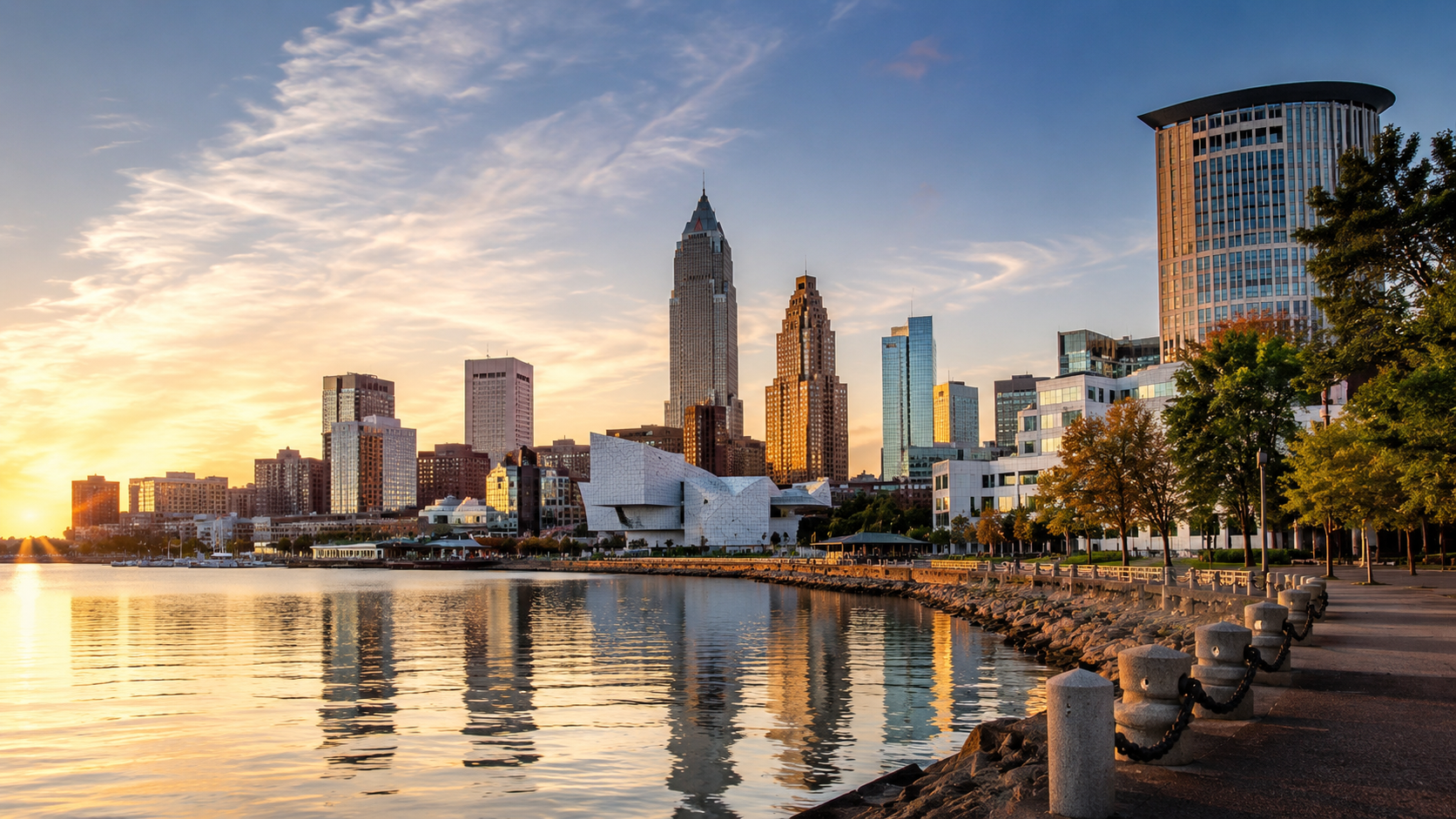 Ohio skyline at golden hour with Cleveland waterfront, Lake Erie reflections, downtown buildings and city promenade.