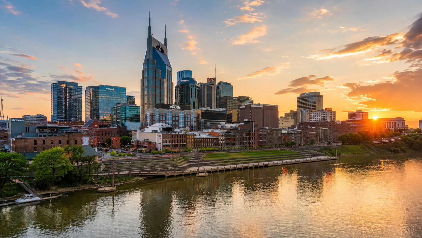 Tennessee skyline at golden hour with Nashville downtown towers, riverfront views and sunset reflections.